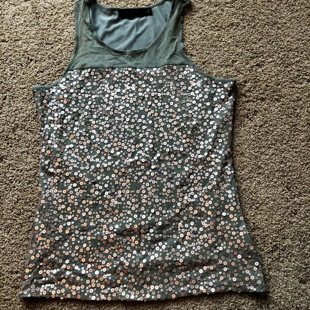 Sheer and sequined sleeveless blouse.